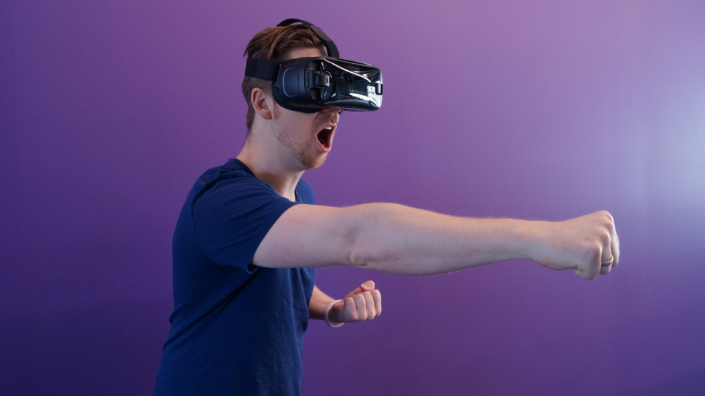 A guy throwing a front punch wearing a VR headset.