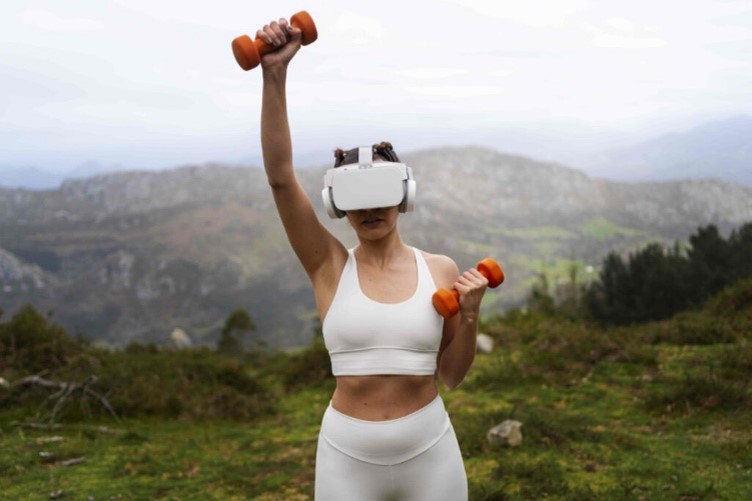 A girl outdoors using dumbbells to workout wearing a VR headset.